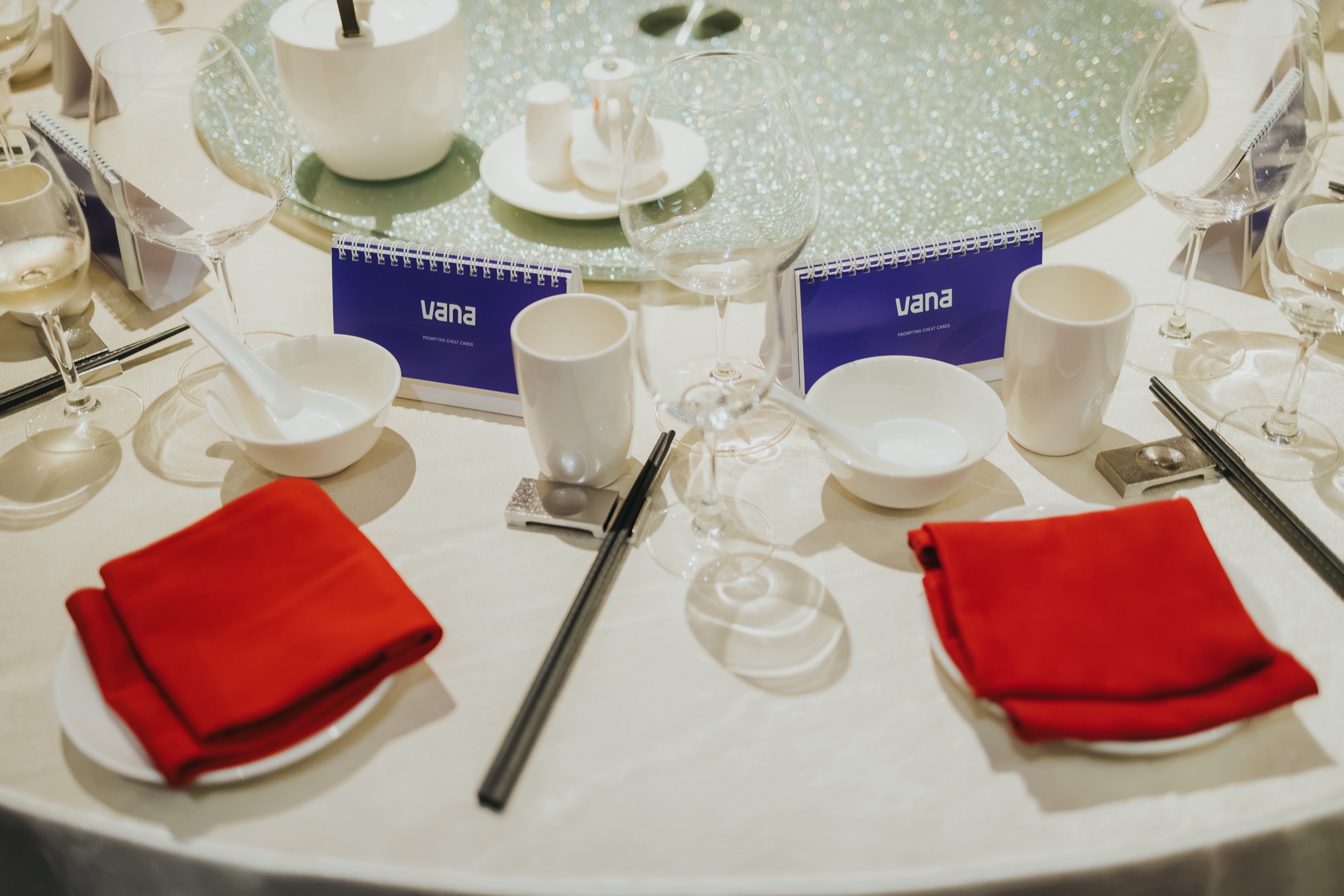Place settings at the table, each with a set of Vana prompting cheat cards.